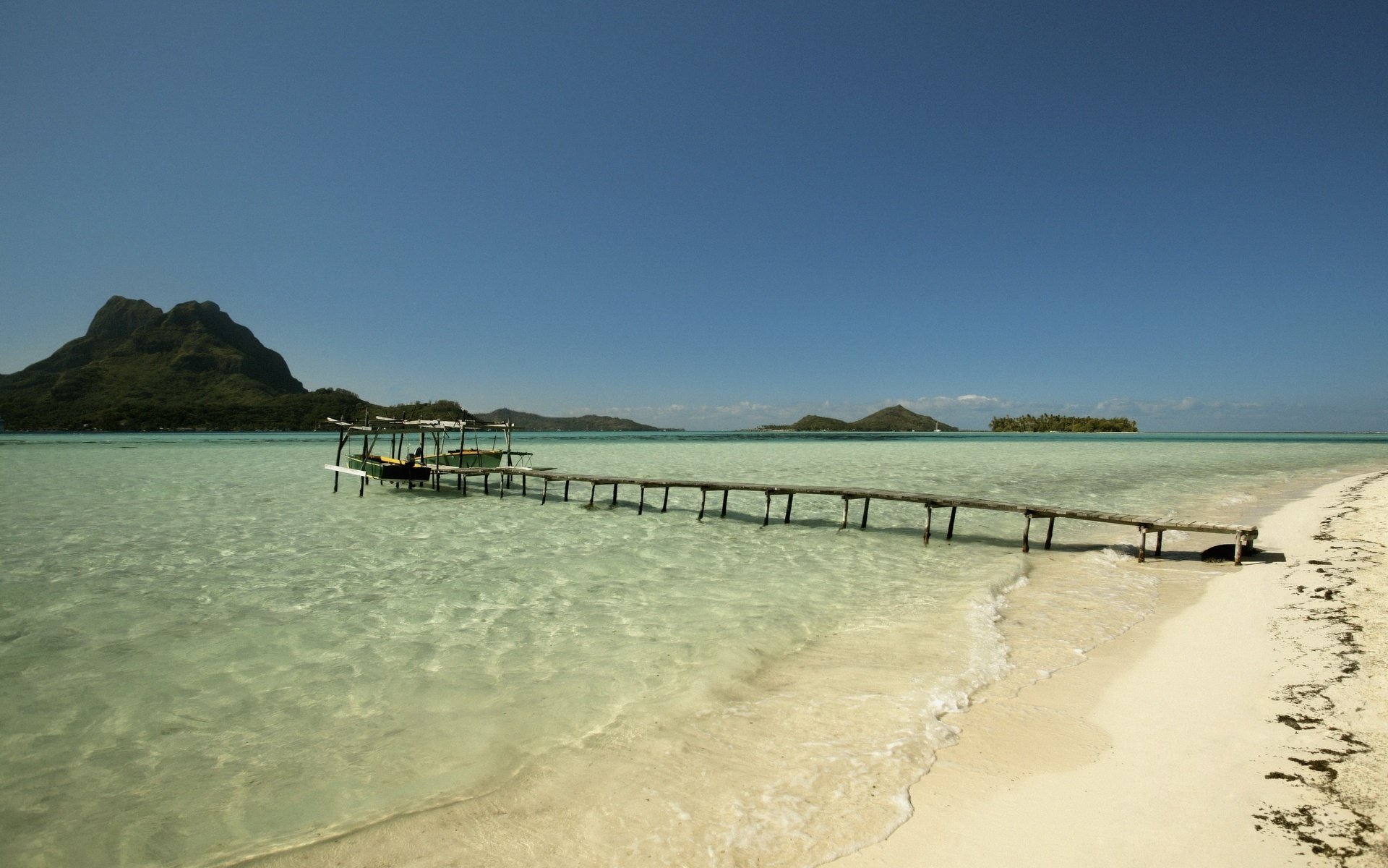 boats pier wooden pier beach water sky sea waves surf mountains pier coast nature landscape sand heat heat summer