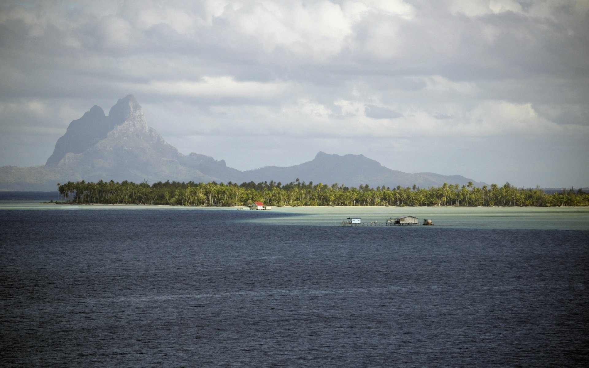 on the eve of the storm coast mountains sea clouds trees islands tropics houses on the water the ocean palm trees vegetation summer resort nature landscape