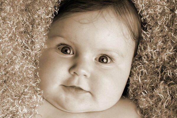 Lächelndes Baby mit erstauntem Blick
