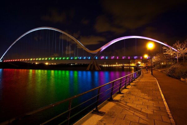 Multicolored lights of the night city on the embankment