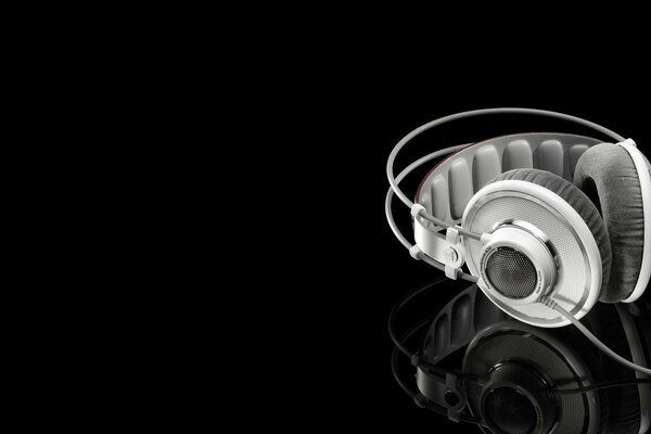 Headphones are broken, lying around and reflected