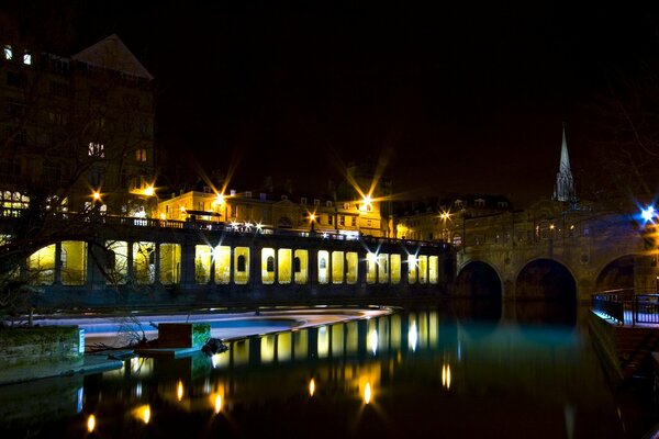 The night light of the city is reflected in the river