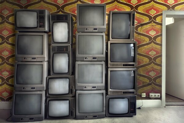 Old TVs stacked in the room