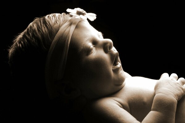 Photo of a sleeping baby in a bandage