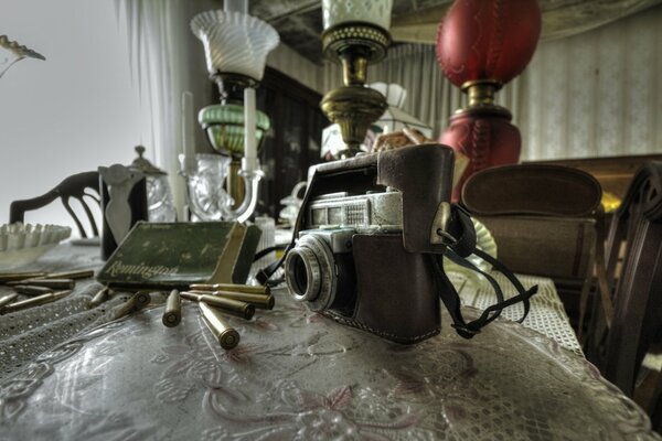 An old camera and a lot of casings on the table