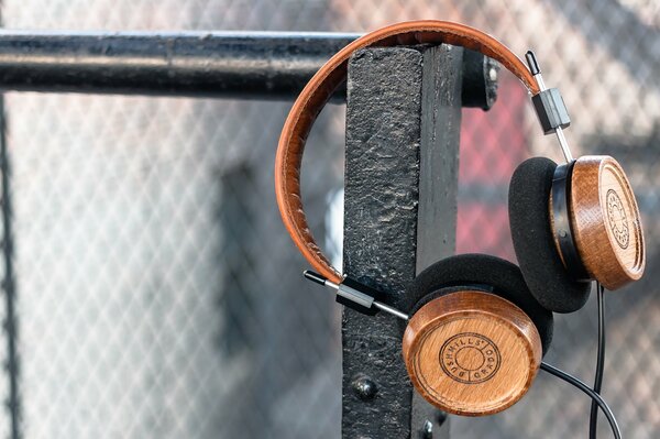 Wooden headphones hanging on the fence