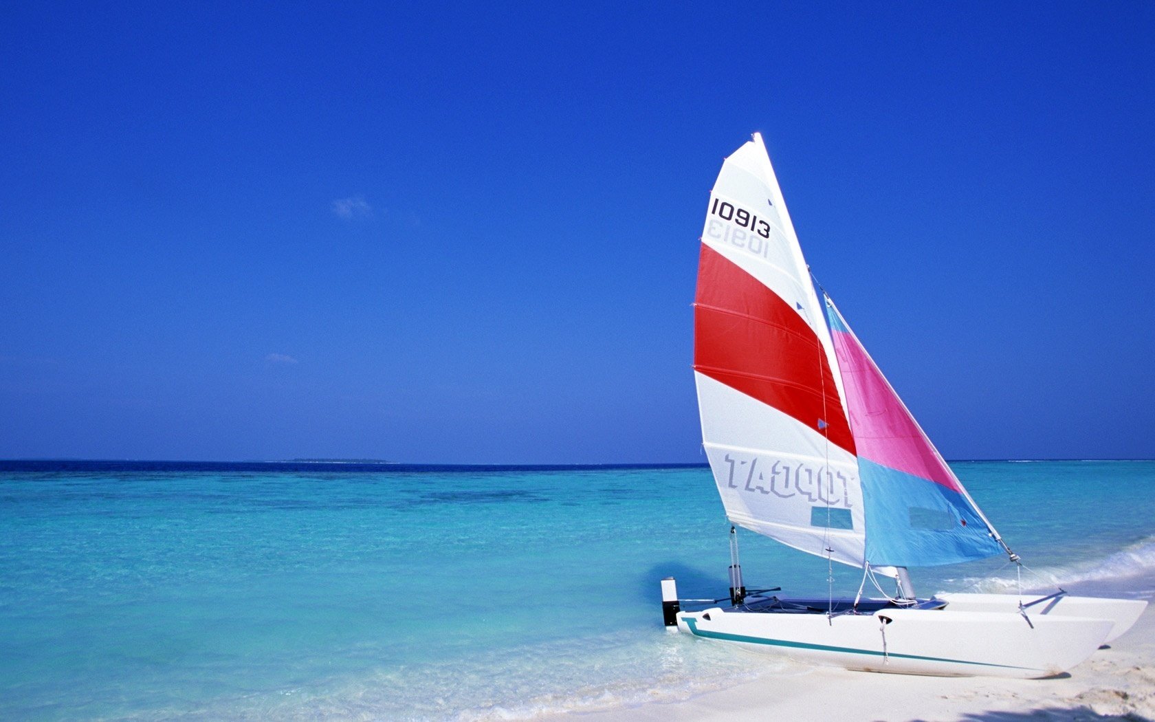 the water sailboat on the sand water the sky yachts blue sky blue nature landscape beach surf the ocean horizon sand summer heat stay vacation resort