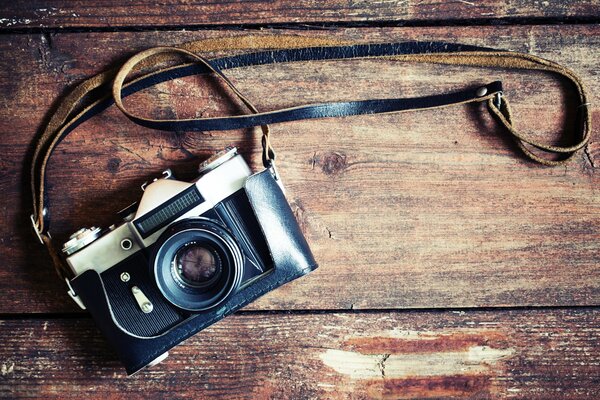 Vintage camera with strap on boards