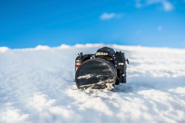 Nikon camera in the snow view from the front