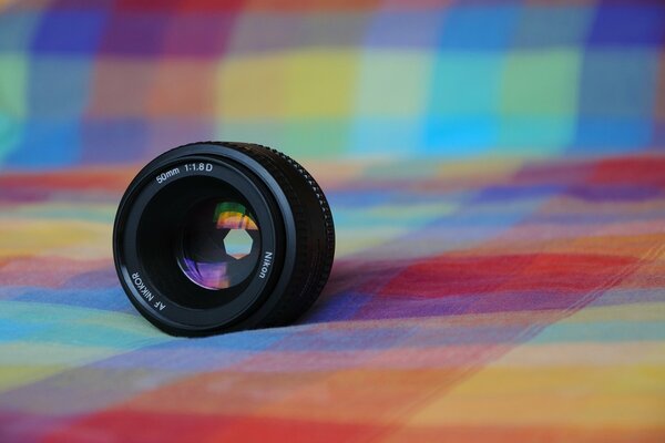 Nikon lens on a background of fabric in a cage