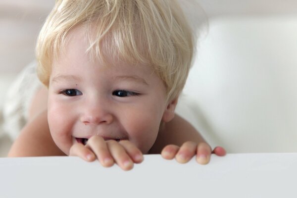 A blond boy with dark eyes