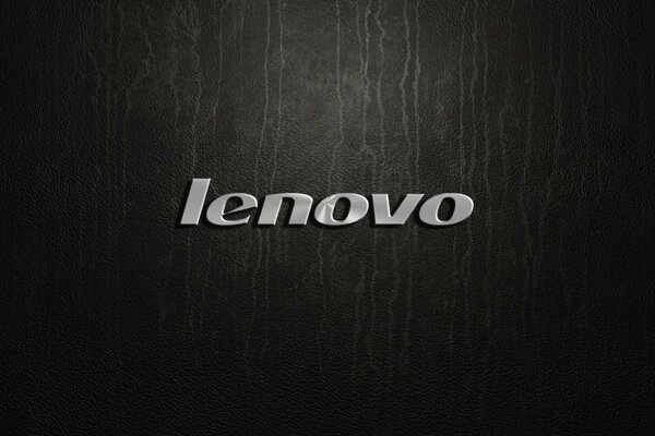 Logotipo plateado de Lenovo sobre fondo negro