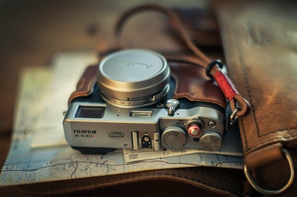 An unusual camera lies in a case on papers