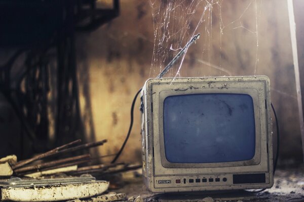 An old TV shrouded in cobwebs