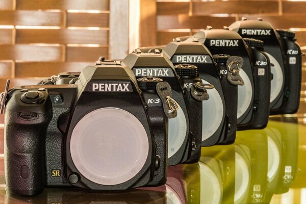 Eine Reihe von Pentax-Kameras auf dem Tisch