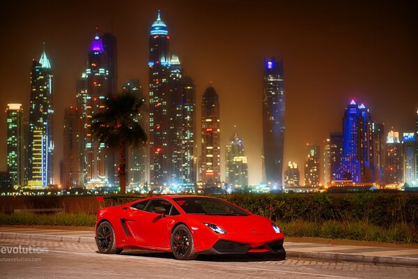 Red Lamborghini on the background of the city