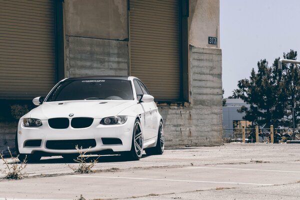 Un BMW blanco con techo negro está a la vuelta de la esquina