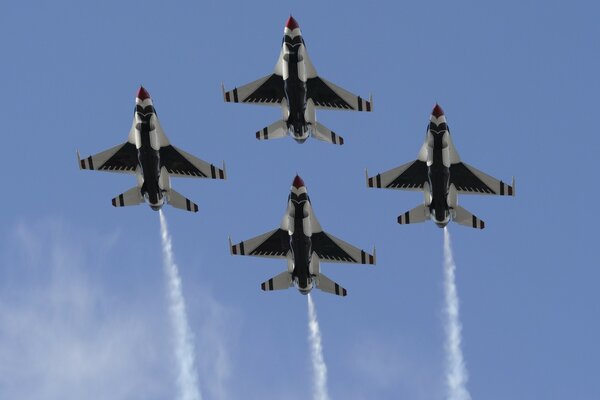 FOUR FIGHTERS FLYING IN FORMATION