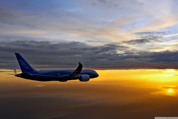 Boeing vole au coucher du soleil, bel éclairage