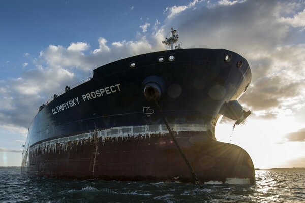 Ship, calm sea. Against the background of the morning sky