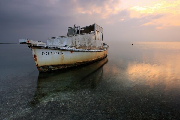 Landscape with an old boat in the lake