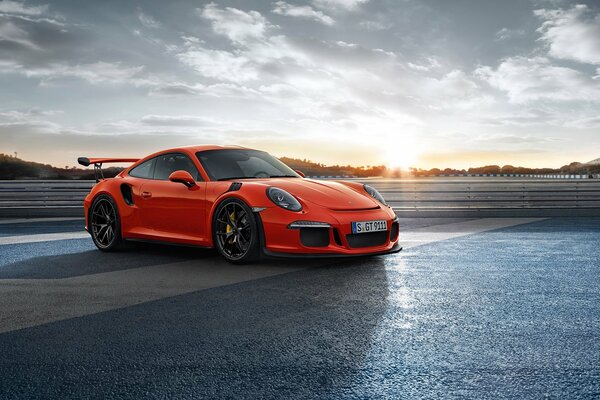 A red 911 Porsche is standing on the playground