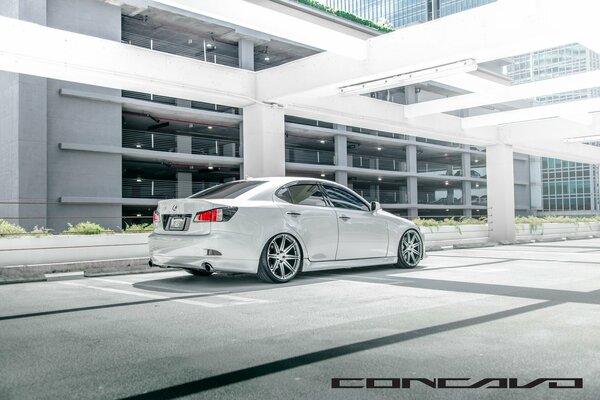 White Lexus concavo on the background of a sunny parking lot