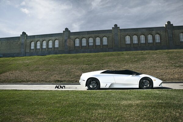 There is a beautiful, white car on the droge