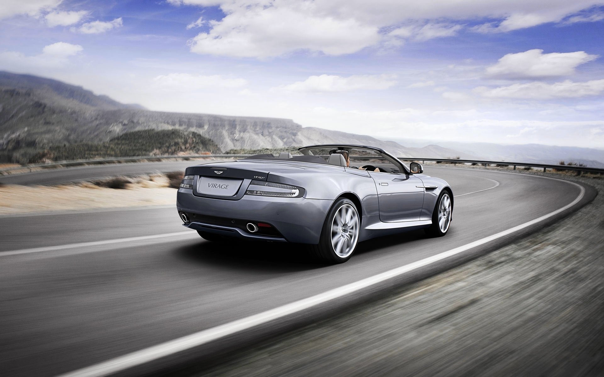 astonm curva volante grigio convertibile cielo auto aston martin nuvole