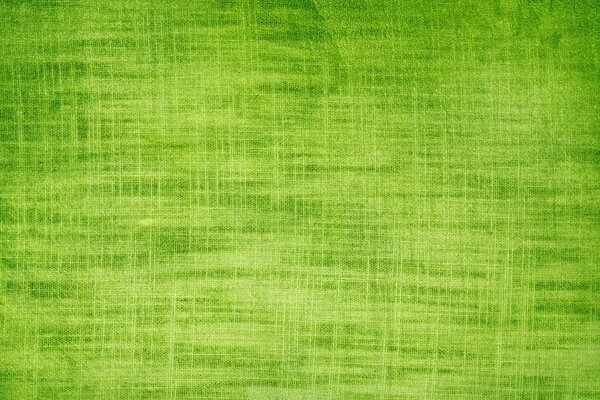 Green background of grass color with texture resembling fabric