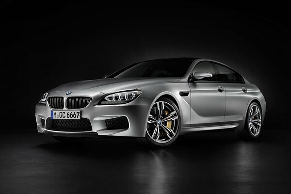 Silver BMW m6 2014 on a black background