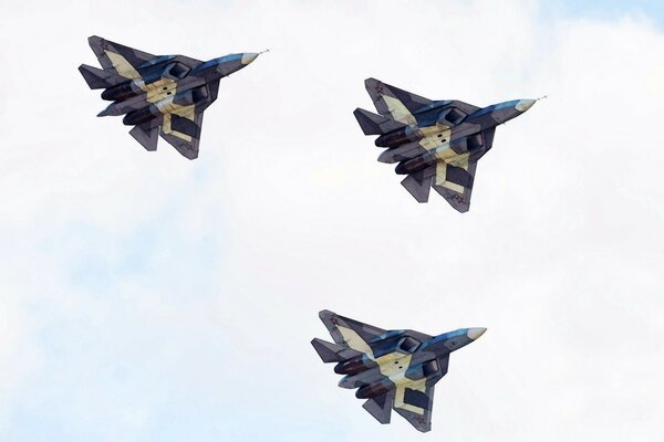 Three military multi-purpose fighters in flight
