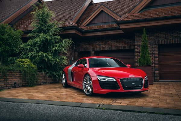 Sports car on the background of a country cottage