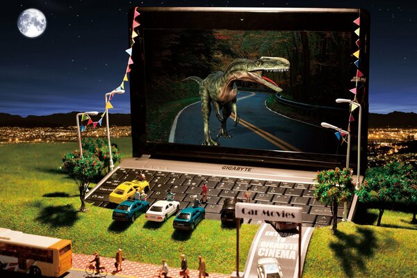 A miniature of a cinema with a large screen on which a dinosaur is running