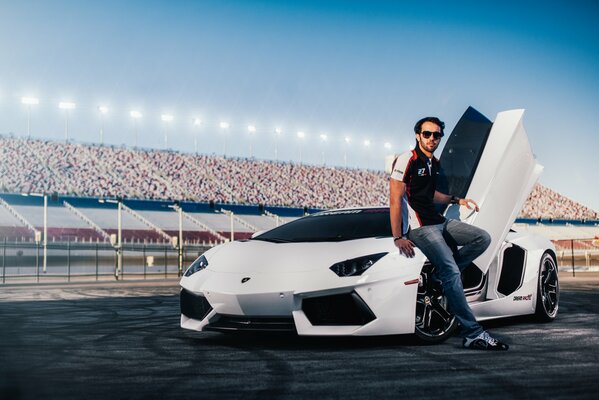 White car on the background of a football field