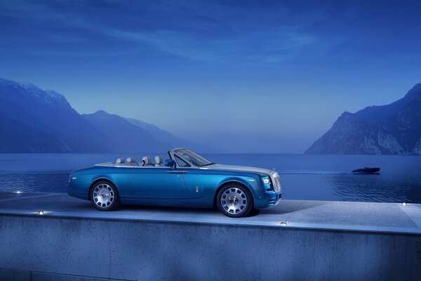 Blue supercar on the background of the sea and mountains