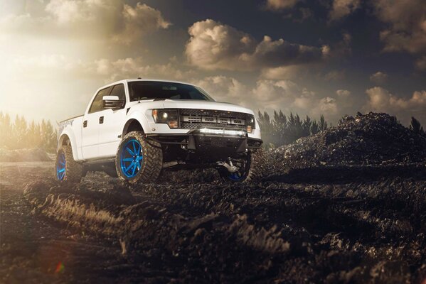 Ford rides on white wheels on the quarry