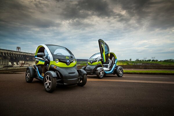 Two electric cars against a cloudy sky