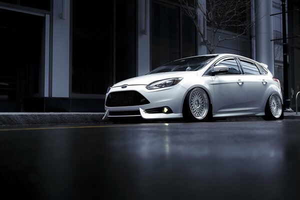 Stylish grey car on a dark background