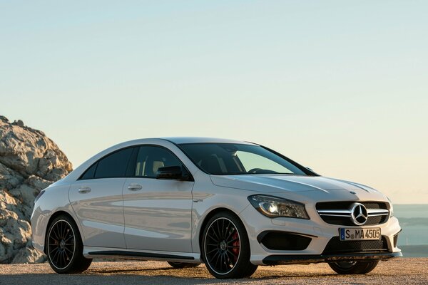 White Mercedes Benz by the sea