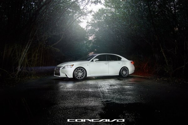 White Lexus on wet asphalt