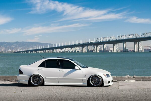 Lexus blanc sur le front de mer sur fond de pont