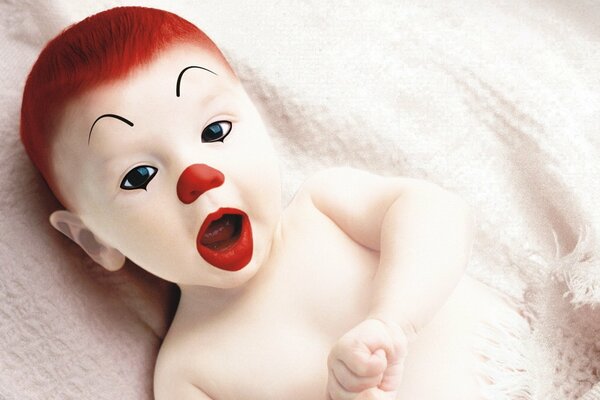 Bébé maquillé sous la forme d un clown avec des cheveux roux