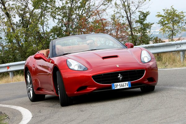 The front of the red Ferrari at the turn of the road