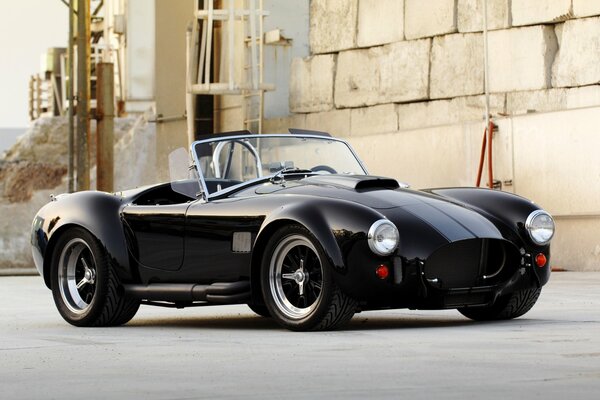 Retro car on the background of a concrete wall