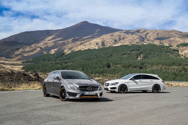 Gray and white Mercedes on the background of a mountain landscape