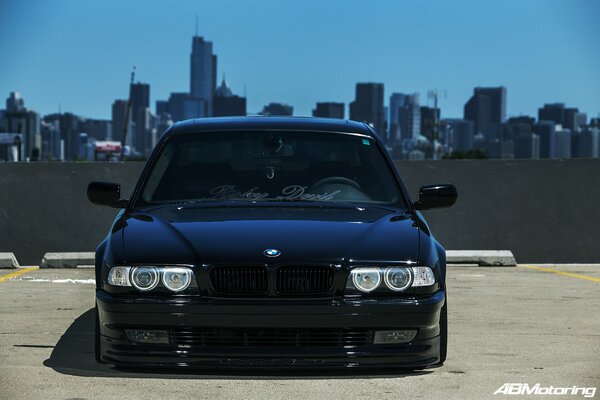 Tuned black BMW E38 on the background of Chicago