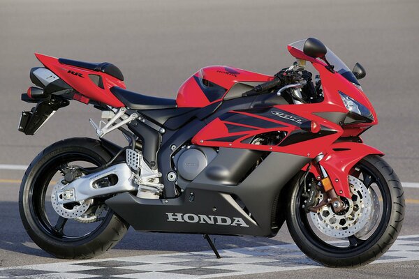 Red honda Sport CBR100 motorcycle on the track