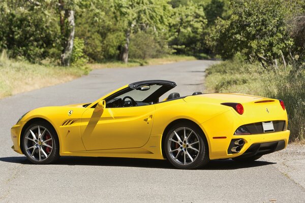 Yellow ferrari car on a landscape background