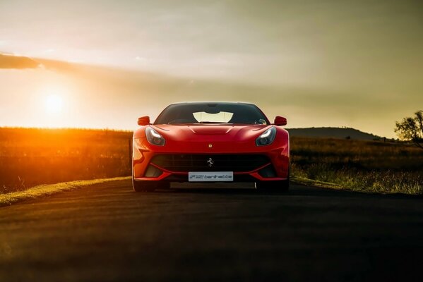 African sunset and Ferrari supercar